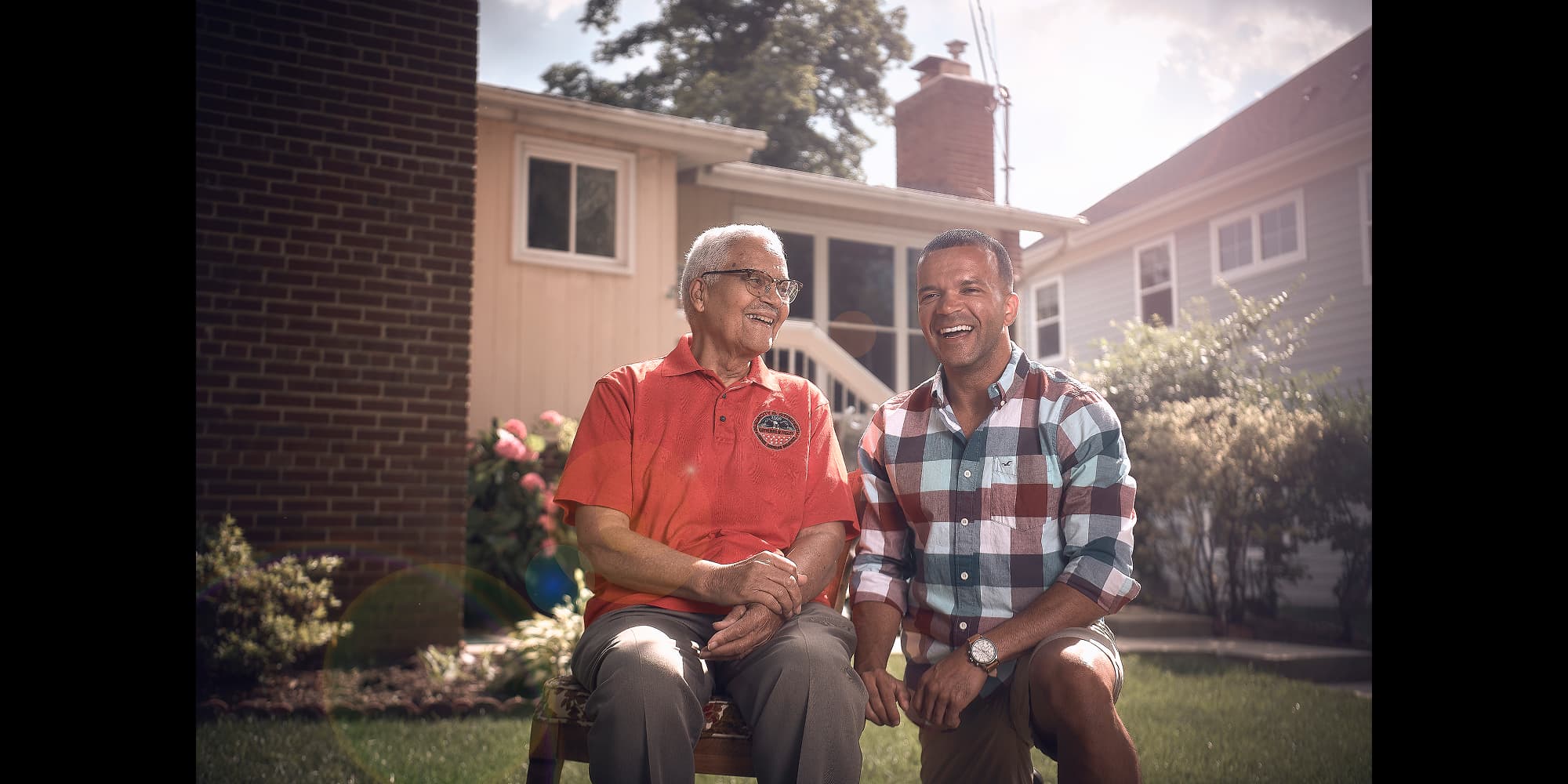Navy supports families with housing costs. Father & son enjoying their home on a sunny day.