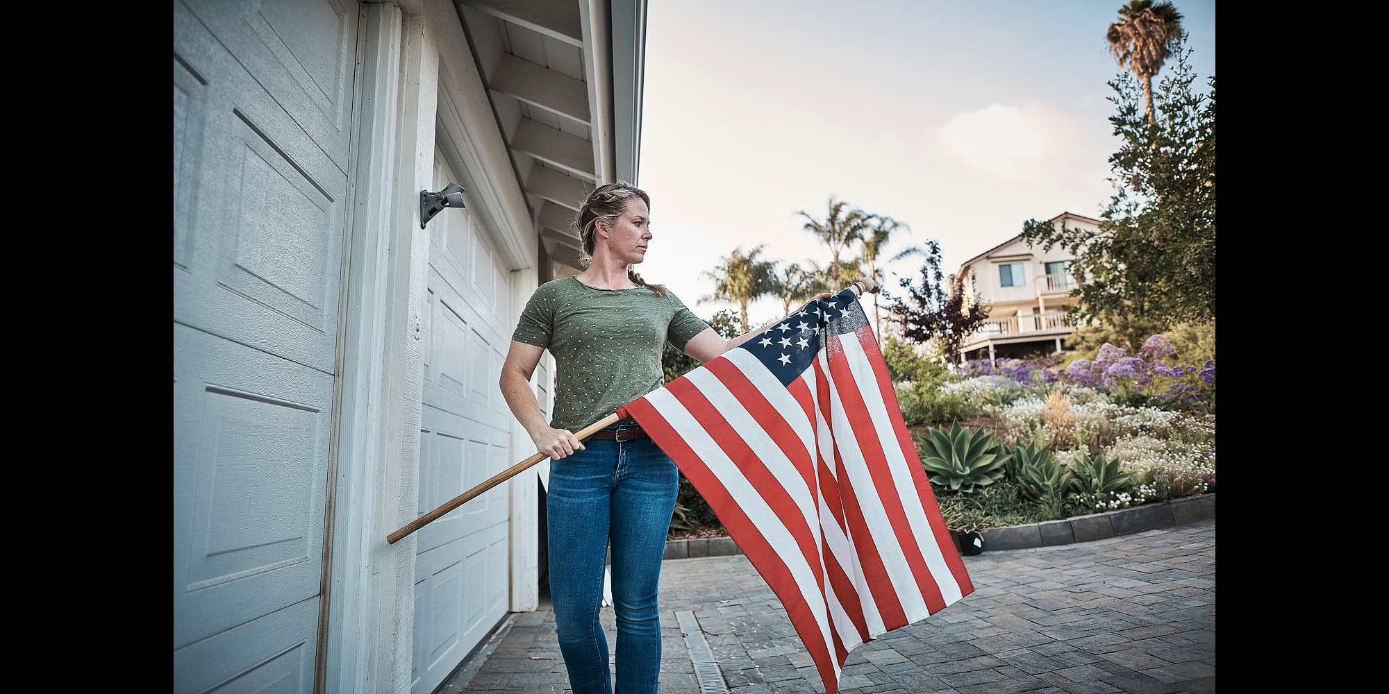 Woman with American flag. Respect for service, reward in retirement. Discover Navy Retirement Benefits.