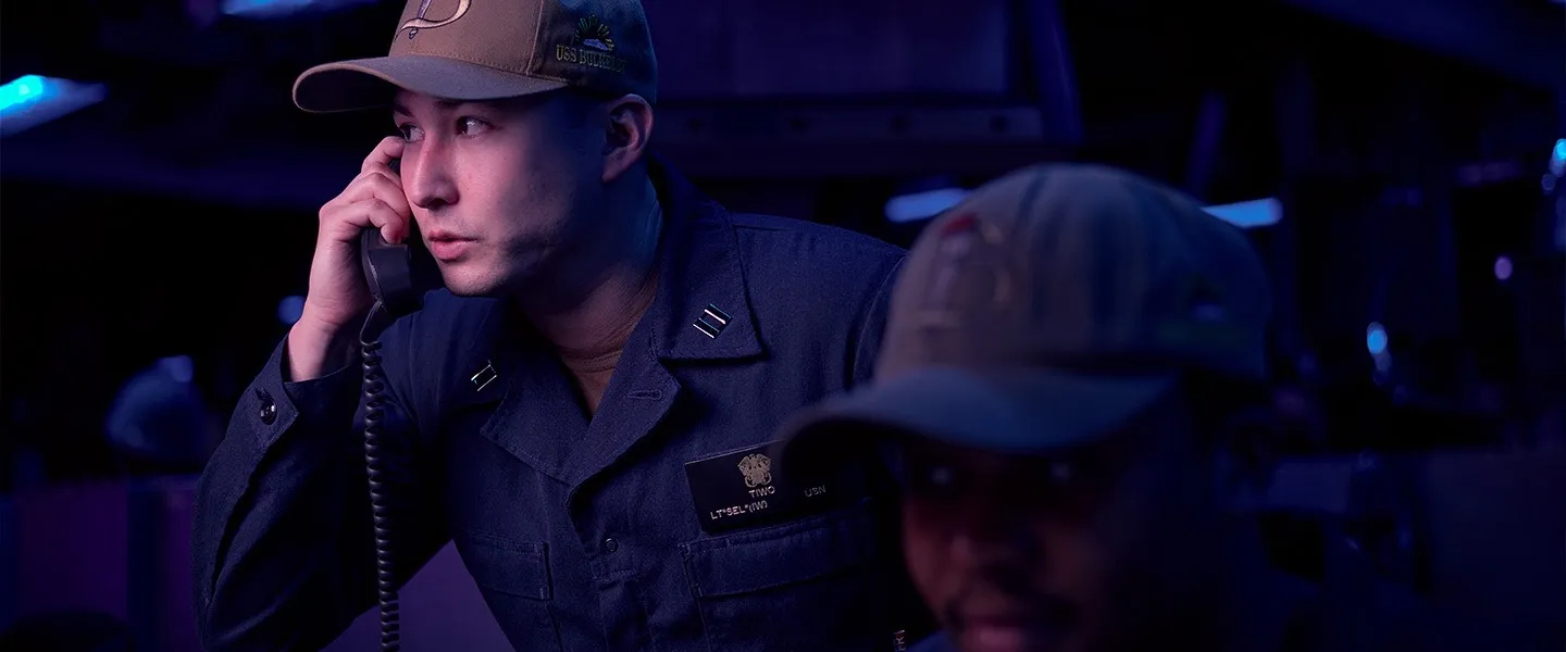 A U.S. Navy Sailor makes a call aboard a ship during a mission.